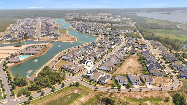 aerial view of property and surrounding area with nearby suburban area and a nearby body of water