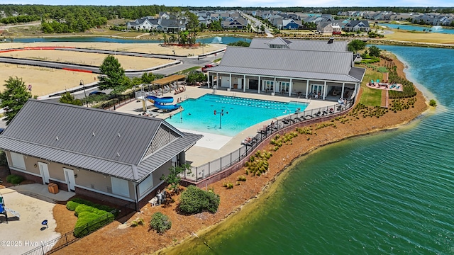 view from above of property with a large body of water and a pool