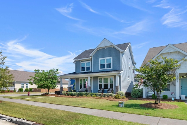 view of front of property with covered porch and a front yard