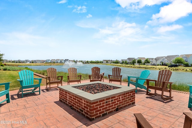 view of patio with an outdoor fire pit and a water view