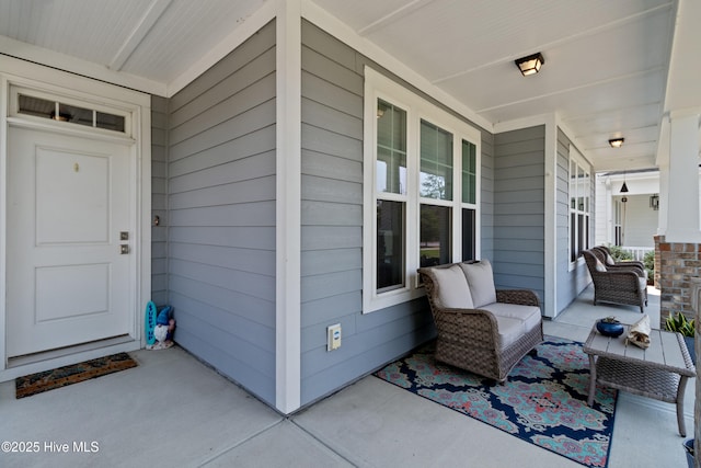 view of exterior entry with covered porch