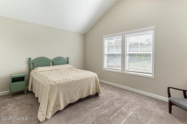carpeted bedroom featuring baseboards and vaulted ceiling