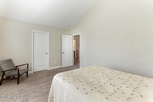 bedroom with carpet floors, baseboards, and vaulted ceiling