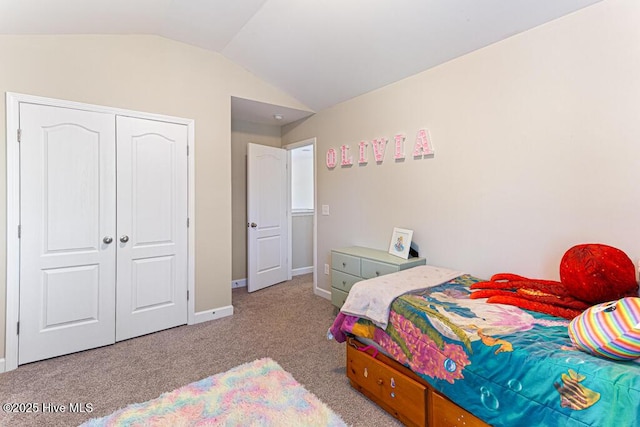 carpeted bedroom with baseboards, lofted ceiling, and a closet