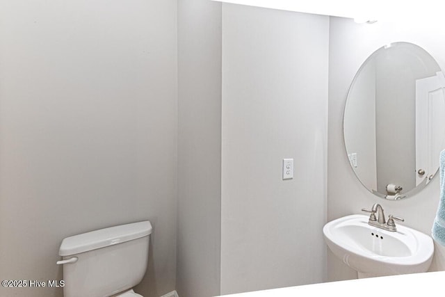 half bathroom featuring toilet