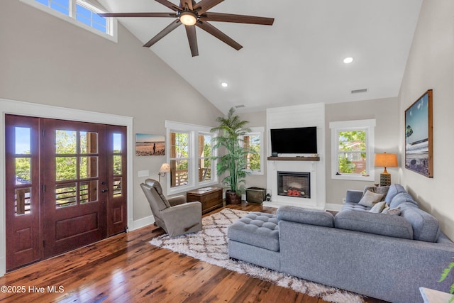 living room with ceiling fan, a fireplace, high vaulted ceiling, recessed lighting, and hardwood / wood-style flooring