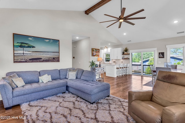 living area with recessed lighting, beam ceiling, ceiling fan, and wood finished floors