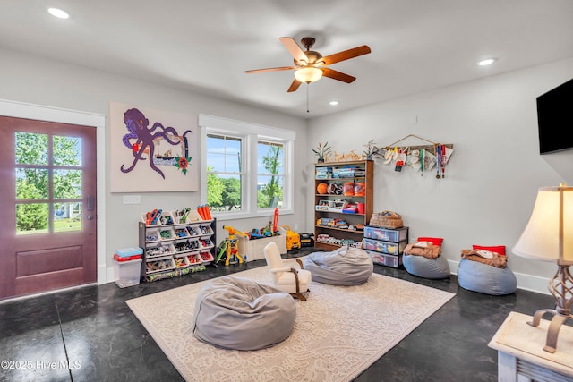 playroom featuring finished concrete flooring, plenty of natural light, recessed lighting, and ceiling fan