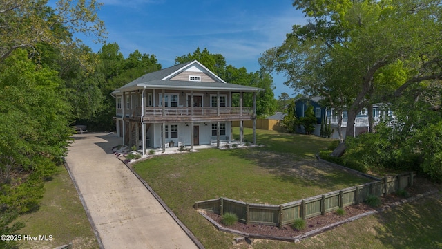 view of front of house featuring french doors, a patio area, a garage, a front lawn, and concrete driveway