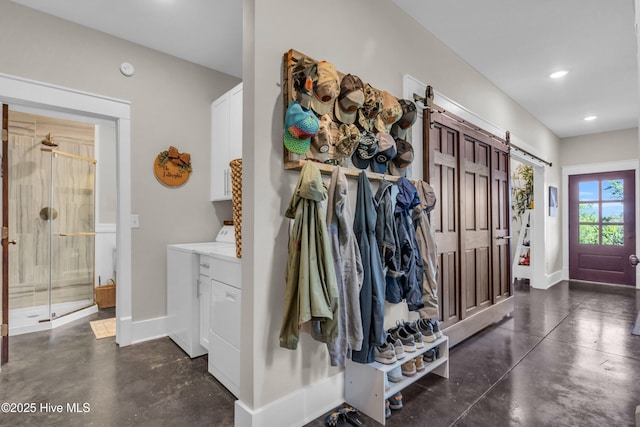 mudroom with a barn door, baseboards, recessed lighting, and finished concrete floors