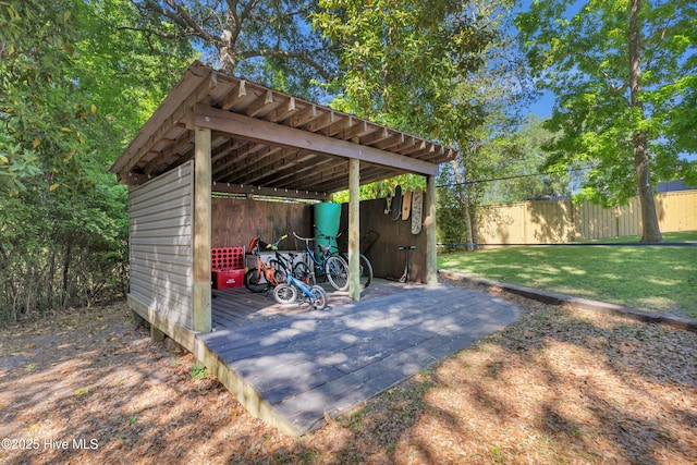 view of outbuilding with fence and an outdoor structure