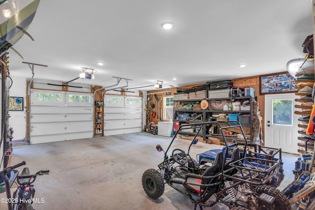 garage with recessed lighting and a garage door opener