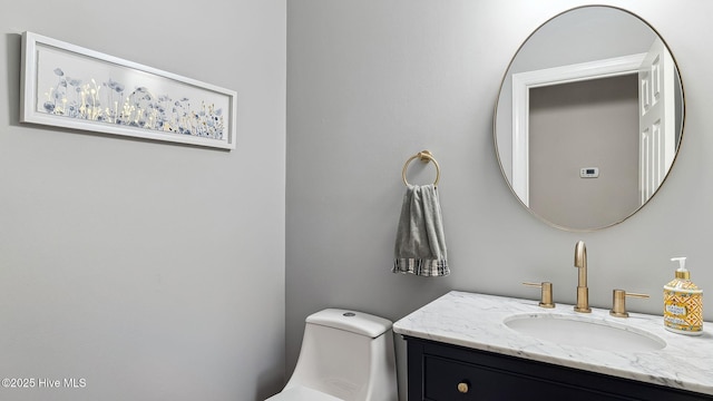 half bathroom featuring toilet and vanity