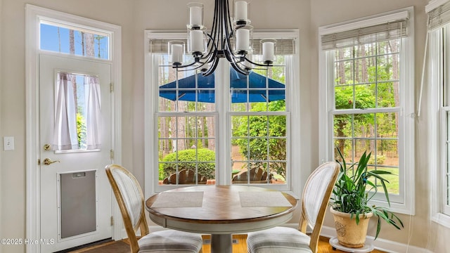sunroom with french doors, a chandelier, and a healthy amount of sunlight