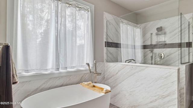 full bathroom with a freestanding bath and a walk in shower