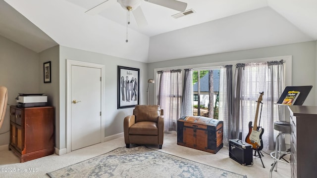 sitting room with ceiling fan, light colored carpet, visible vents, baseboards, and vaulted ceiling