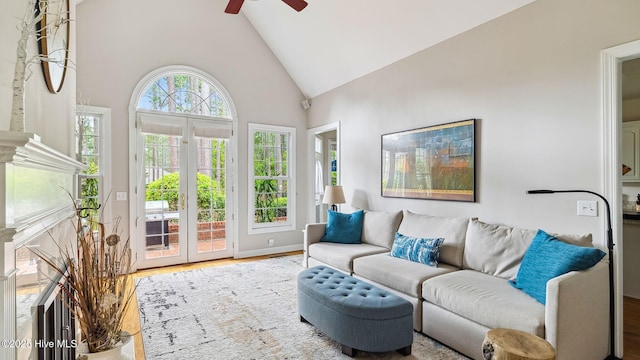 interior space featuring baseboards, ceiling fan, wood finished floors, and high vaulted ceiling