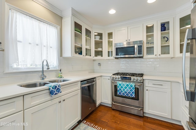 116 SE 20th St, Oak Island, NC 28465 - kitchen featuring light countertops, white cabinetry, tasteful backsplash, a sink, and stainless steel appliances