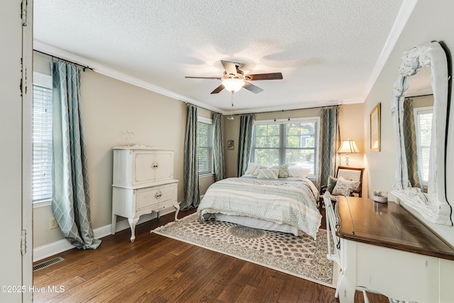 116 SE 20th St, Oak Island, NC 28465 - bedroom with a textured ceiling, visible vents, dark wood finished floors, baseboards, and ornamental molding