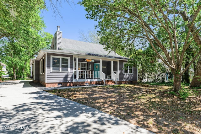 116 SE 20th St, Oak Island, NC 28465 - ranch-style house featuring ceiling fan, covered porch, a chimney, crawl space, and concrete driveway