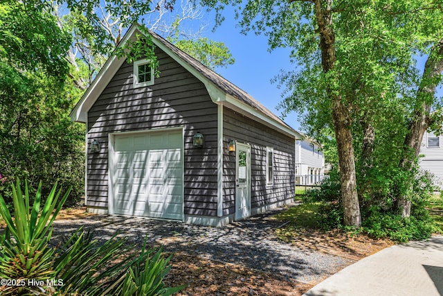 116 SE 20th St, Oak Island, NC 28465 - view of home's exterior featuring a garage, an outbuilding, and driveway