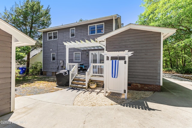 116 SE 20th St, Oak Island, NC 28465 - rear view of property with a pergola and a deck