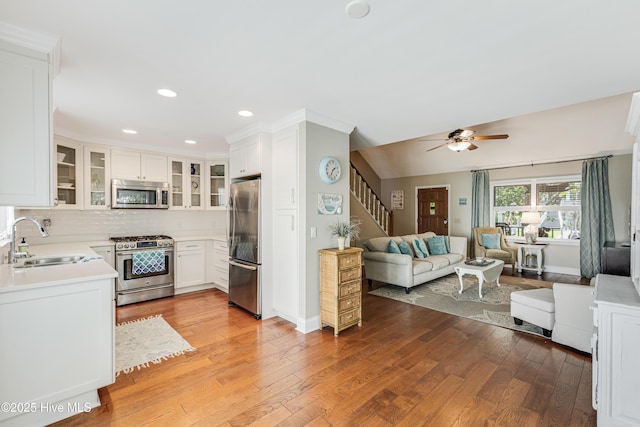 116 SE 20th St, Oak Island, NC 28465 - kitchen featuring a sink, stainless steel appliances, open floor plan, recessed lighting, and light wood-type flooring