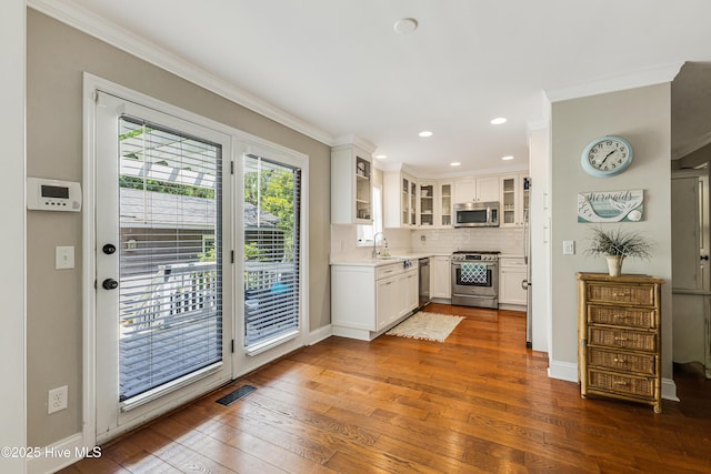 116 SE 20th St, Oak Island, NC 28465 - kitchen with crown molding, a sink, dark wood-style flooring, and appliances with stainless steel finishes