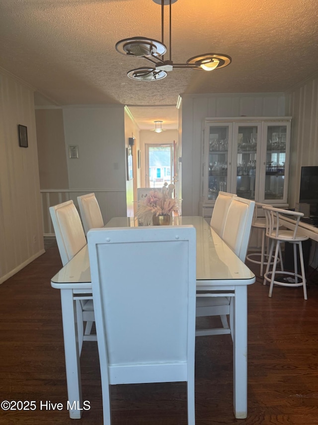 212 S Spence Ave, Goldsboro, NC 27534 - dining room featuring a textured ceiling, wood finished floors, and a decorative wall