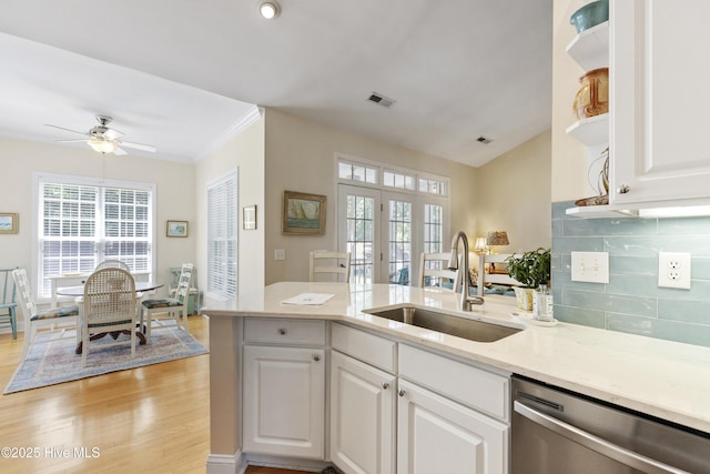 3733 Winstead Cir, Southport, NC 28461 - kitchen featuring stainless steel dishwasher, open shelves, a peninsula, white cabinetry, and a sink