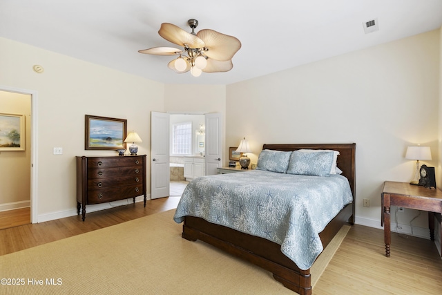 3733 Winstead Cir, Southport, NC 28461 - bedroom with light wood finished floors, ensuite bath, a ceiling fan, baseboards, and visible vents