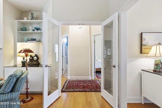3733 Winstead Cir, Southport, NC 28461 - interior space with a wainscoted wall, french doors, and wood finished floors
