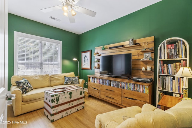 3733 Winstead Cir, Southport, NC 28461 - living room with a ceiling fan, wood finished floors, and visible vents