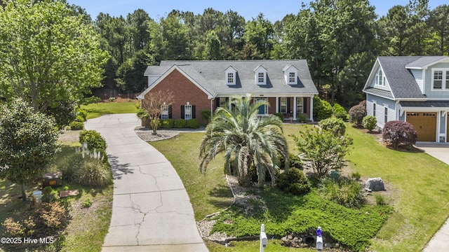 3733 Winstead Cir, Southport, NC 28461 - new england style home featuring driveway, brick siding, and a front yard