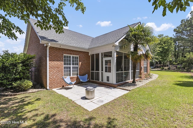 3733 Winstead Cir, Southport, NC 28461 - back of property featuring roof with shingles, a lawn, a sunroom, brick siding, and a patio