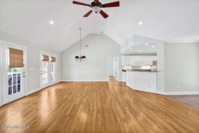 600 Sea Castle Ct, Wilmington, NC 28412 - unfurnished living room featuring light wood finished floors, ceiling fan with notable chandelier, baseboards, and recessed lighting