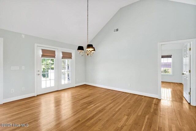 600 Sea Castle Ct, Wilmington, NC 28412 - interior space with light wood-style flooring, high vaulted ceiling, visible vents, baseboards, and a chandelier