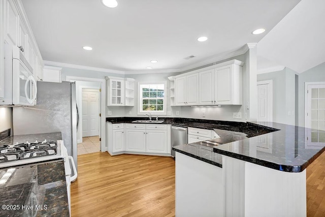 600 Sea Castle Ct, Wilmington, NC 28412 - kitchen with a sink, a peninsula, white appliances, ornamental molding, and light wood-type flooring