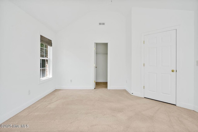 600 Sea Castle Ct, Wilmington, NC 28412 - unfurnished bedroom featuring lofted ceiling, baseboards, carpet flooring, visible vents, and a walk in closet