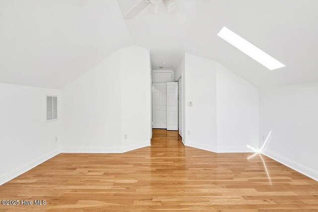 600 Sea Castle Ct, Wilmington, NC 28412 - bonus room featuring light wood finished floors, visible vents, baseboards, and vaulted ceiling with skylight