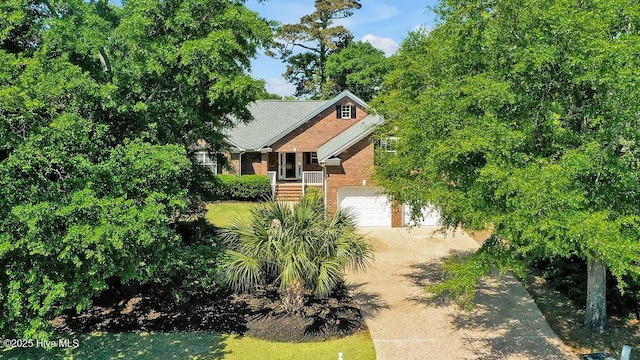 600 Sea Castle Ct, Wilmington, NC 28412 - obstructed view of property with a garage, brick siding, and driveway