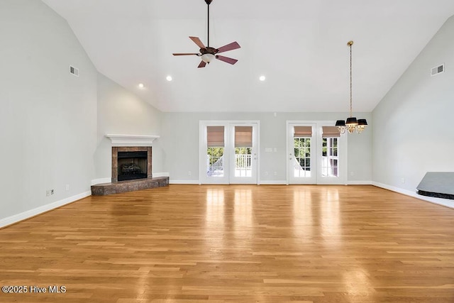 600 Sea Castle Ct, Wilmington, NC 28412 - unfurnished living room with ceiling fan with notable chandelier, light wood-style flooring, visible vents, and high vaulted ceiling