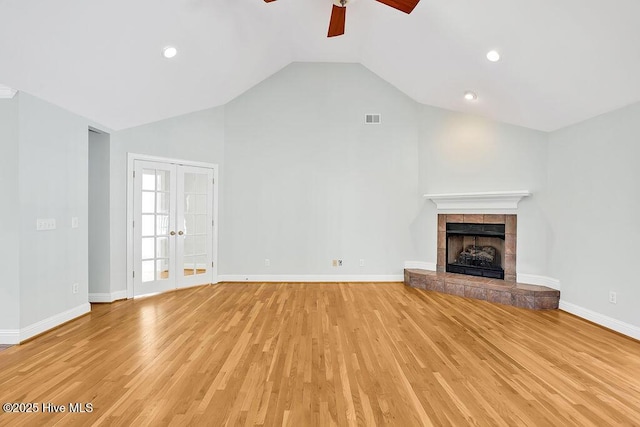 600 Sea Castle Ct, Wilmington, NC 28412 - unfurnished living room featuring visible vents, vaulted ceiling, a fireplace, light wood-style flooring, and a ceiling fan