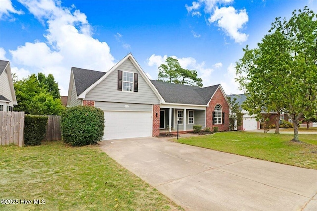traditional-style home featuring brick siding, fence, a front yard, and concrete driveway