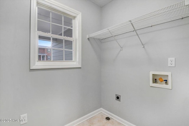 clothes washing area featuring hookup for an electric dryer, washer hookup, laundry area, and baseboards