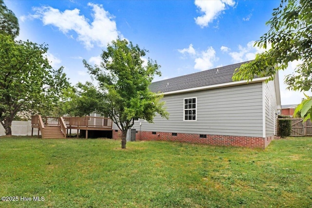 rear view of house featuring a yard, a deck, crawl space, and fence