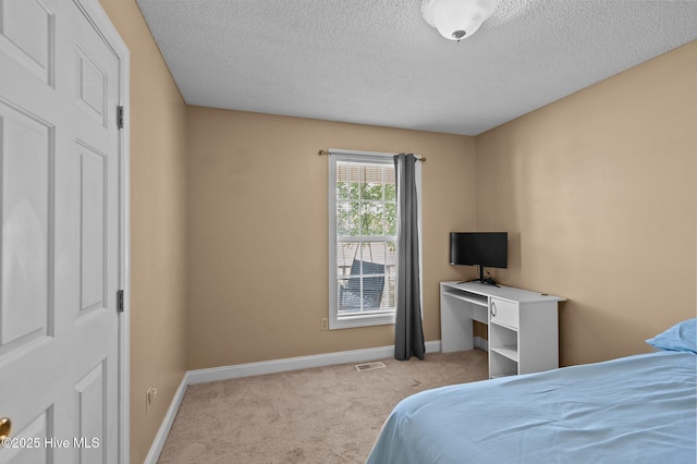 5065 Chris Rd, Bailey, NC 27807 - carpeted bedroom featuring a textured ceiling, visible vents, and baseboards