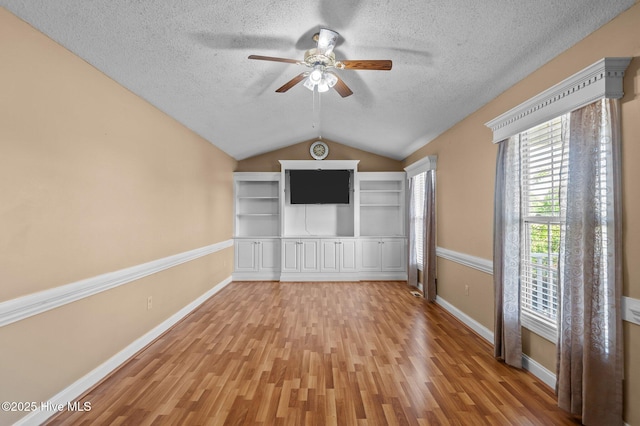 5065 Chris Rd, Bailey, NC 27807 - unfurnished living room with lofted ceiling, baseboards, light wood-type flooring, a textured ceiling, and a ceiling fan