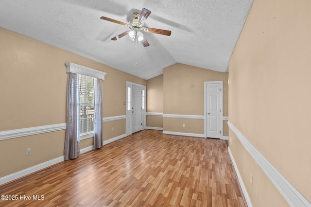 5065 Chris Rd, Bailey, NC 27807 - spare room featuring light wood-style floors, ceiling fan, a textured ceiling, and lofted ceiling