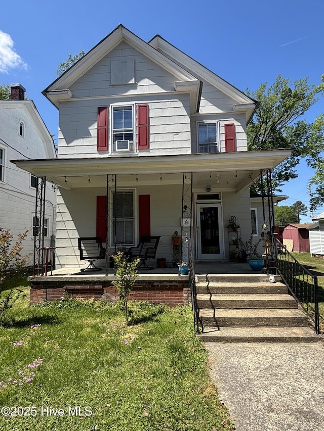 view of front of home featuring fence, cooling unit, a porch, and a front yard